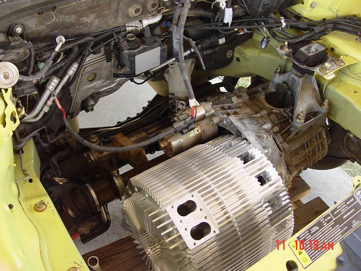 MYT engine being mounted into a yellow 2001 Ford Focus